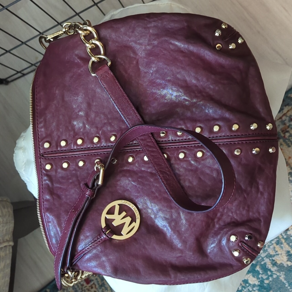 Oxblood leather purse with gold studs and chain